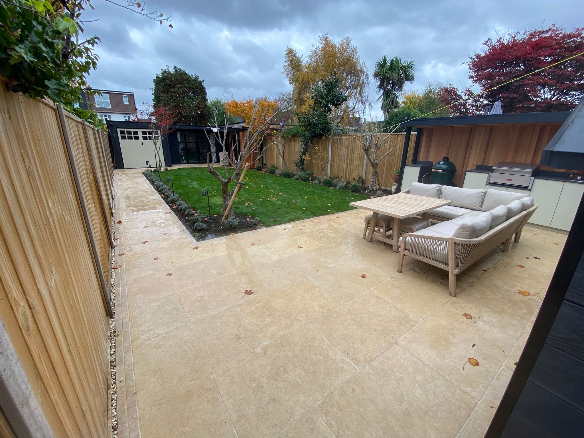wide view shot of patio paved with furniture and bbq
