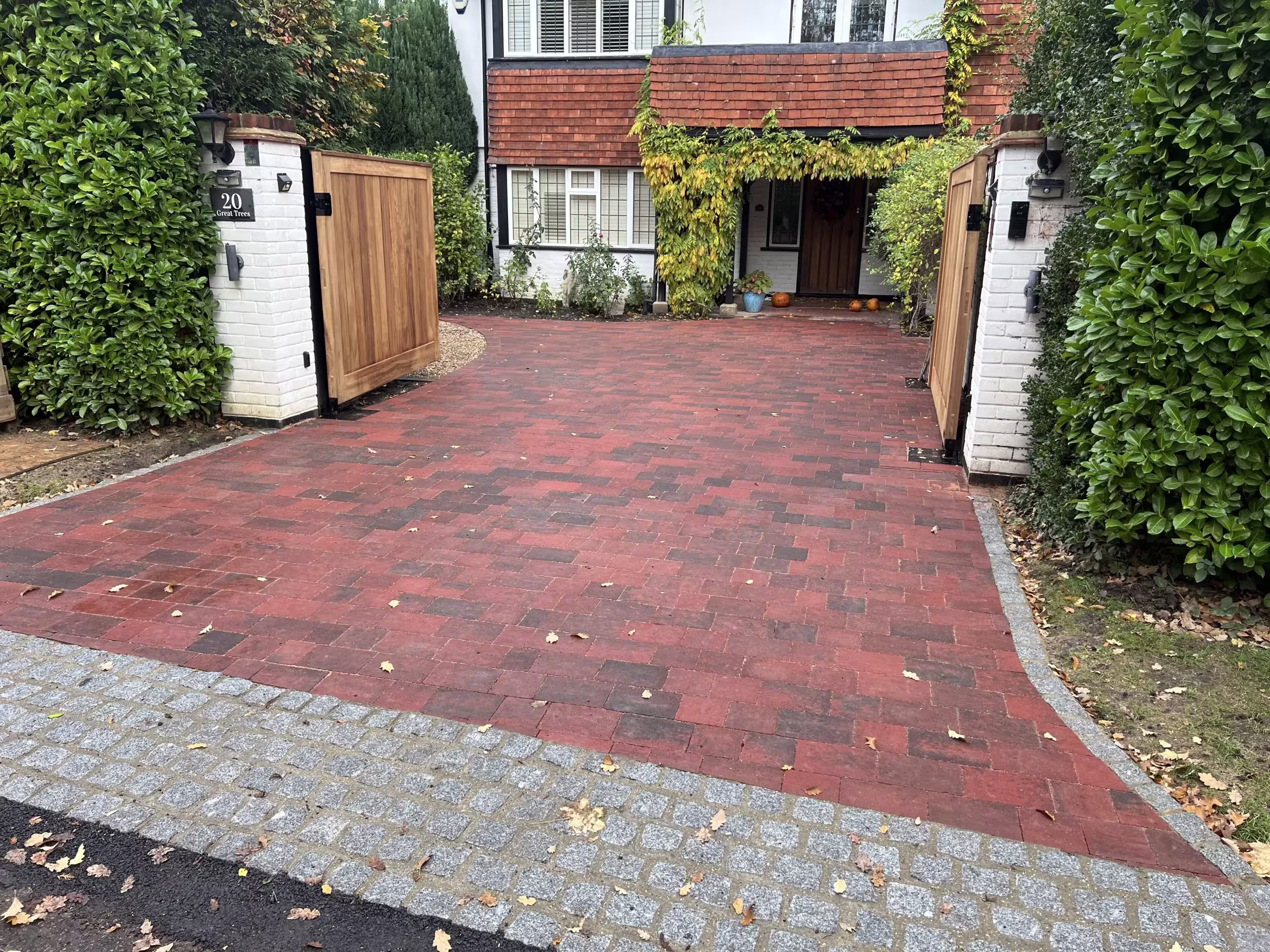 red bricked front drive with gates open